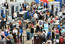 Ebola Travel Ban Chaos: Are We REALLY Safe? Crowd at an airport security checkpoint with TSA officers.