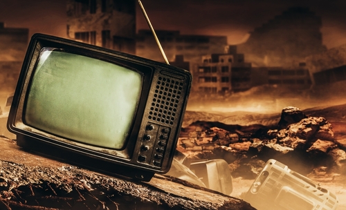 An old, broken television set in a desolate, post-apocalyptic landscape