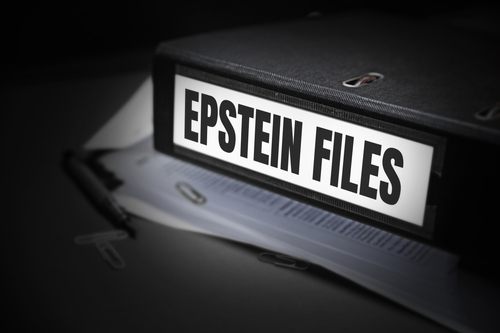 A black binder labeled 'EPSTEIN FILES' with papers and office supplies nearby