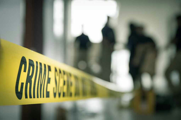 Crime scene tape with people in the background.