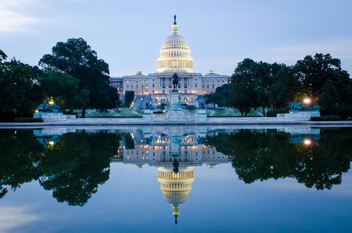 shutterstock110970671jpg-1 United States Capitol building reflected in a calm pool at dusk