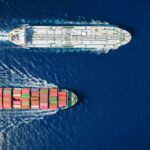 Blockade Eases as Tankers Exit Hormuz Two cargo ships navigating through the ocean