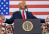 Trump Unveils Declassified Election Intelligence Files Person speaking at a podium with American flag backdrop.