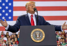 Trump Unveils Declassified Election Intelligence Files Person speaking at a podium with American flag backdrop.