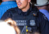 Secret Service officer wearing tactical gear and radio.
