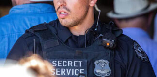 Secret Service officer wearing tactical gear and radio.