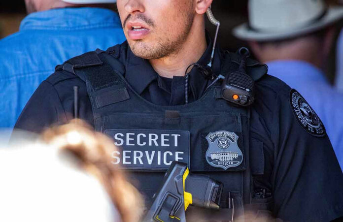 2346861587-1 Secret Service officer wearing tactical gear and radio.