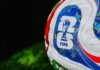 Close-up of a FIFA-branded soccer ball on grass