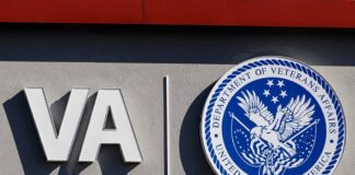VA logo and Department of Veterans Affairs seal on building wall
