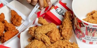 A variety of fried chicken pieces served in takeout containers