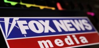 Close-up of the Fox News media logo on a digital screen