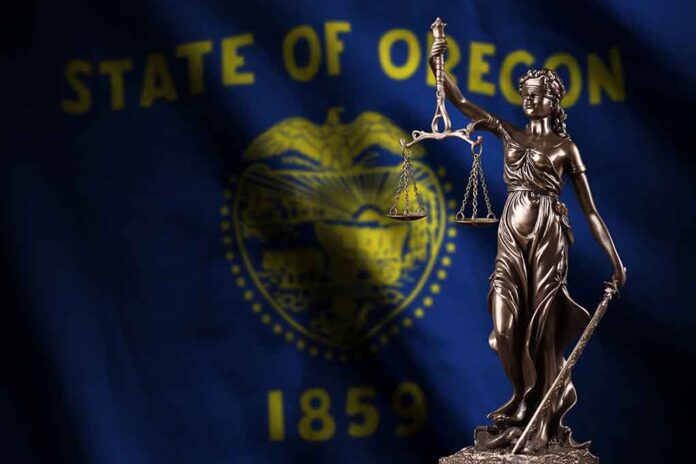 Lady Justice statue in front of Oregon flag.