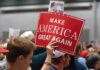 Person holding a Make America Great Again sign.