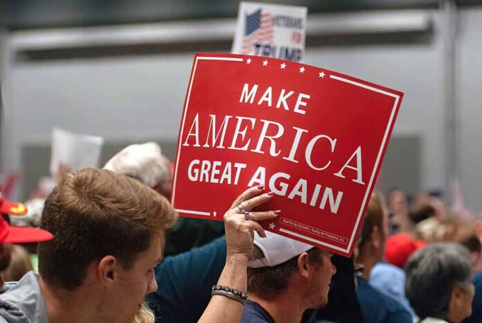 Person holding a Make America Great Again sign.