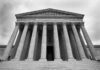 Supreme Court building with columns and ornate inscription.