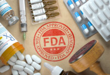 FDA approved stamp with various pills and medicines.