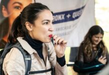 Woman eating candy at outdoor event.